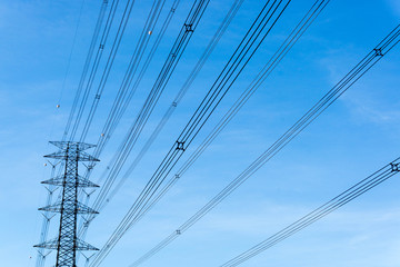 High voltage towers with sky background.