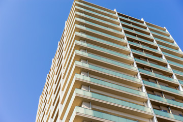 Wall Mural - Real estate image, apartment building against blue sky