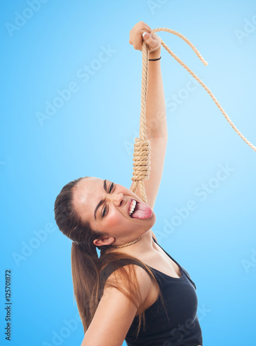 Fotografie, Obraz portrait of a young woman hanging with a rope