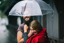 Guy And Girl Under An Umbrella