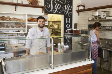 Wall Mural - Staff working behind the counter at a sandwich bar