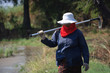 © Tee11 - Thai farmer carrying hoe.