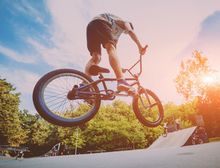 boy jumping with his bmx in the park.