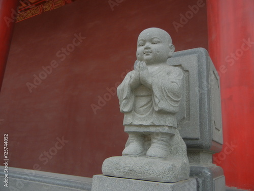 Fotografie, Obraz Apprentice Buddhist Monk Statue at White Pagoda Temple in Manchuria City Shenyan