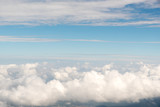 Fototapeta Niebo - Cloudscape view above white clouds and blue sky from airplane