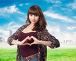 © asierromero - young woman doing a heart symbol