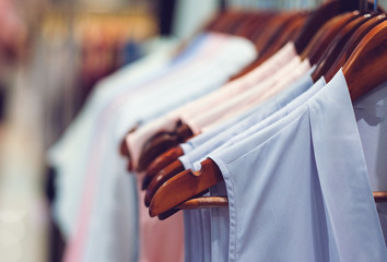 close up clothes hang on clothes rack in clothing store with swe