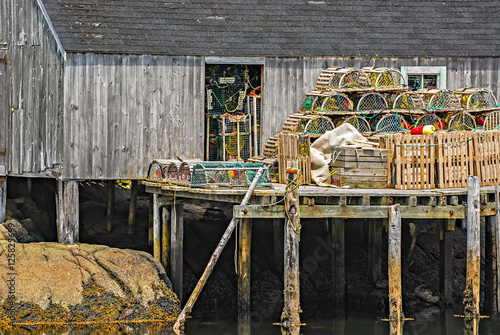 Wooden fishing pier with lobster traps set up and ready for a day of fishing Poster