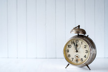 Old Alarm Clock On A White Background - Selective Focus, Copy Space