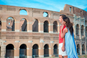 Happy family in Europe. Romantic couple in Rome over Coliseum background. Italian european vacation