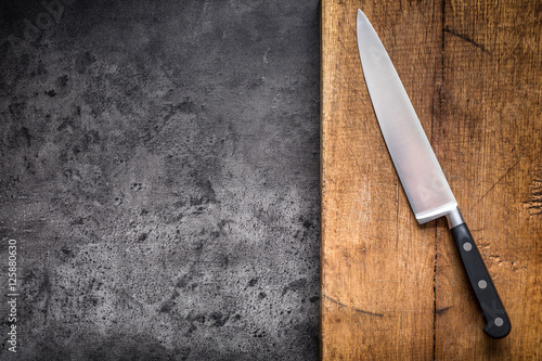Fotografía Kitchen knife on concrete or wooden board.