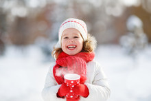 Happy Child Girl With A Cup Of Hot Tea In Winter  Walk
