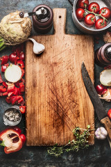 Wall Mural - Healthy food background with aged cutting board,  cooking pot ,vegetables and kitchen knife, top view, frame