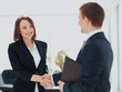 © ASDF - Two professional business people shaking hands