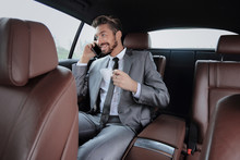 Young Businessman Having A Coffee In His Car