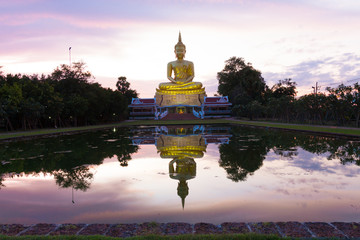 Wall Mural - Golden Buddha images on sky clouds background in evening. Golden Buddha statue in a Buddhist temple