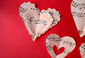 Sticker - Paper hearts with music notes on red background