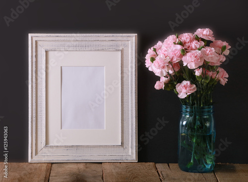 A Horizontal Presentation Of A Rustic White Wood Frame And A Teal