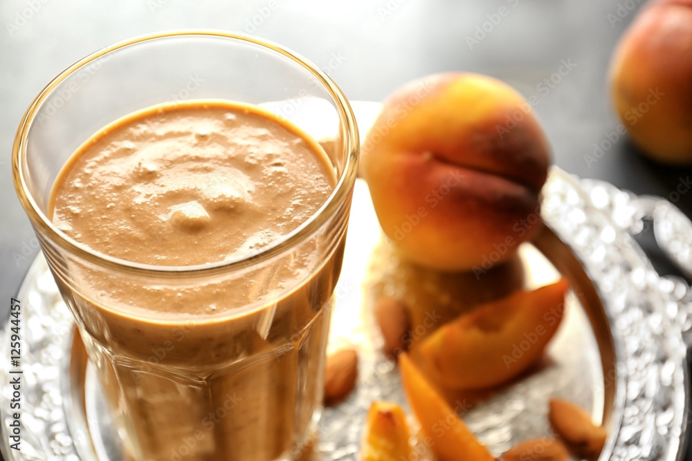 Close up view of glass with smoothie on blurred background
