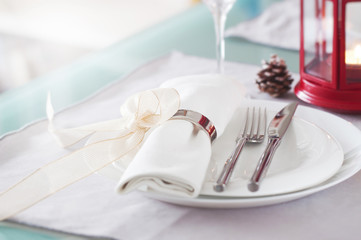 Poster - Elegant decorated Christmas table setting with modern cutlery, napkin, bow and christmas decorations. Christmas menu concept, closeup, horizontal