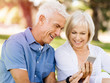 © Sergey Nivens - Happy senior couple looking at smartphone
