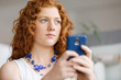 © Sergey Nivens - Happy beautiful young businesswoman using smart phone smiling