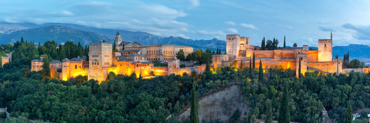 Wall Mural - Panorama of Moorish palace and fortress complex Alhambra with Comares Tower, Alcazaba, Palacios Nazaries and Palace of Charles V during evening blue hour in Granada, Andalusia, Spain