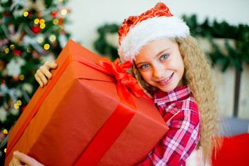 happy child girl with Christmas gifts