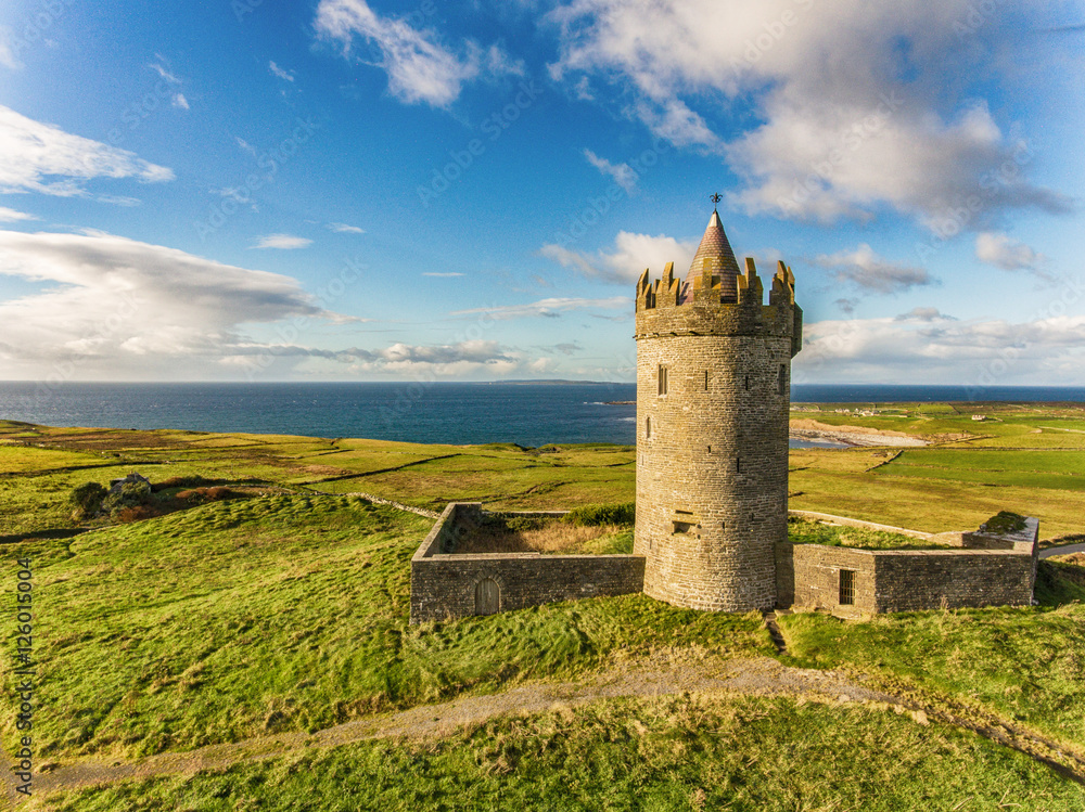 Obraz na płótnie Aerial Famous Irish Tourist Attraction In Doolin, County Clare, Ireland. Doonagore Castle is a round 16th-century tower Castle. Aran Islands and along The Wild Atlantic Way. w salonie