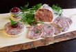 Homemade headcheese with dill and cranberries on a wooden board