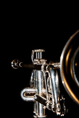 Wall Mural - trumpet, wind instrument / lonely musical instrument which is a trumpet on a black background
