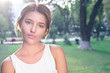© jon11 - Bautiful girl wearing a white shirt poses in a city park