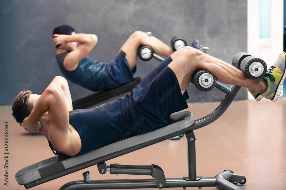 Young man training in fitness gym