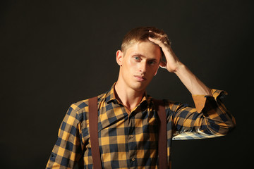 Portrait of stylish man on dark background