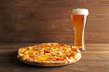 Sticker - Tasty pizza with beer on wooden table