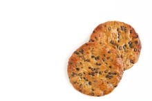 Rice Crackers With Black Sesame Seeds On White Background