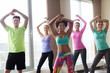 © Syda Productions - group of smiling people dancing in gym or studio