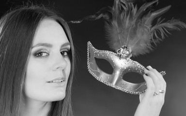 Woman holding carnival mask closeup