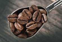 Group Of Coffee Beans On A Spoon
