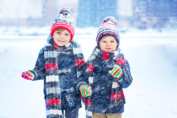 Wall Mural - Happy children having fun with snow in winter