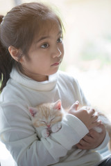 Wall Mural - Happy little Asian girl hugging lovely scottish fold kitten