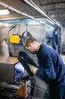© hedgehog94 - Factory for production of heavy pellet stoves and boilers. Close up shot of manual worker's hand welding some parts.
