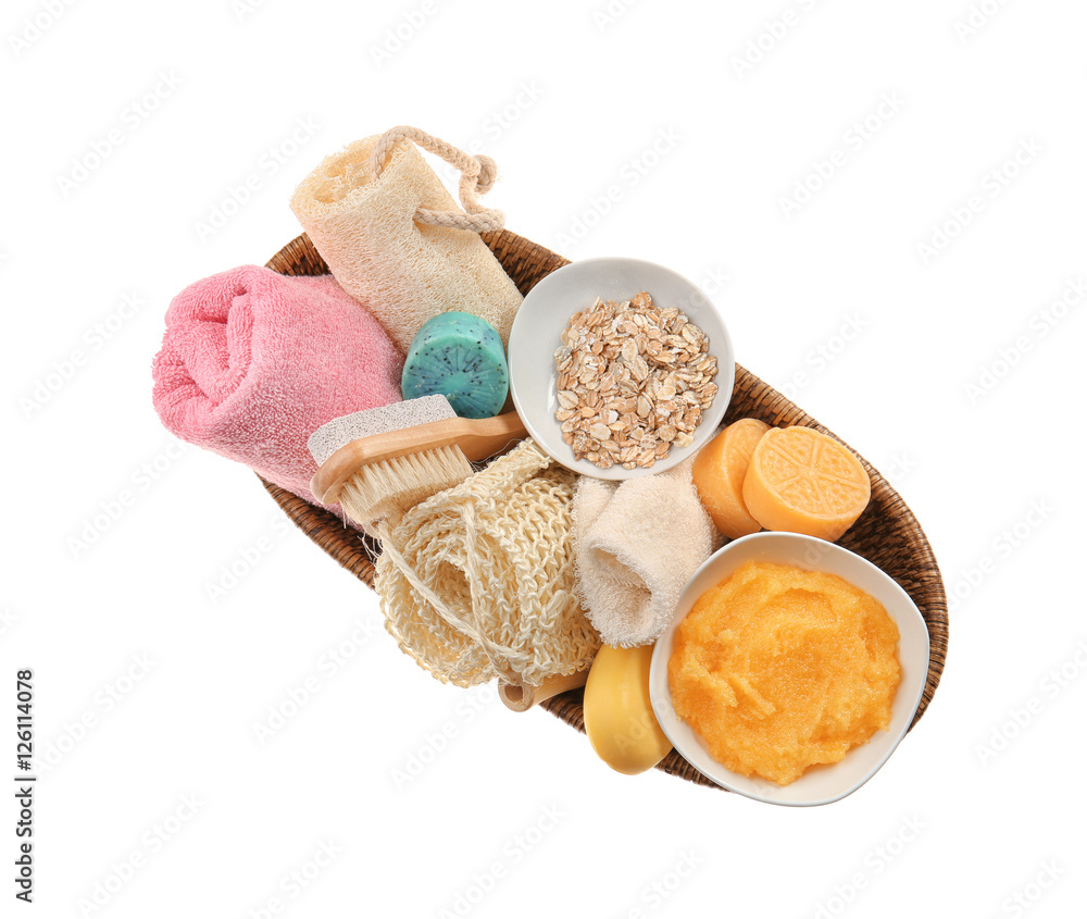 Body care set with oatmeal in wicker basket on white background