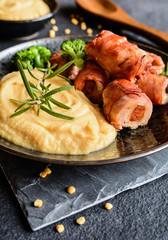 Wall Mural - Roasted pork cutlets wrapped in bacon and stuffed with sausage, served with peas puree