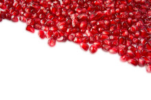 Background Made Of Red Pomegranate Seeds. The Scattered Red Grains Of A Pomegranate. Top View.