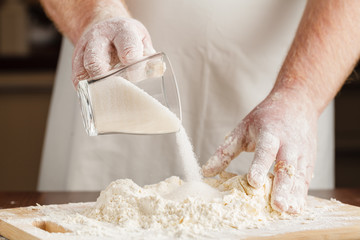 Wall Mural - flour pours from a glass plate in preparation for test