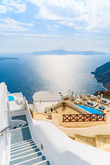  View of sea and and typical Greek boutique hotel with swimming pool in Imerovigli village, Santorini island, Greece