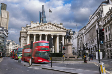 Wall Mural - London, England - The Royal Exchange building with moving red double decker buses