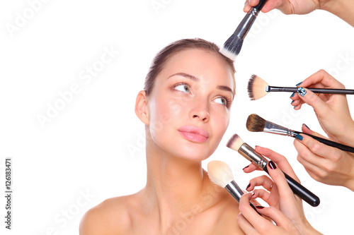 Poster Young woman with make up brush, isolated on white background