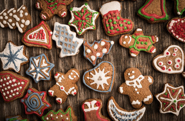 colorfully christmas cookies on rustic wooden background